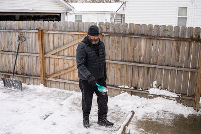 Full length of man standing in snow