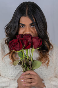Portrait of woman holding rose bouquet