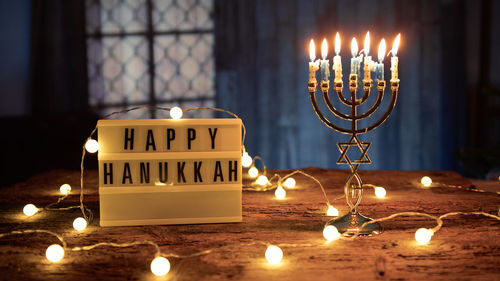 Close-up of illuminated candles on table