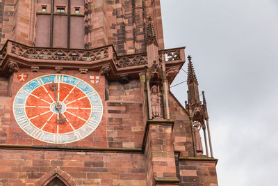 Low angle view of clock tower against sky