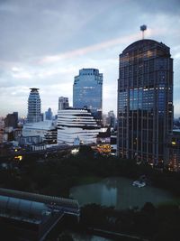 Buildings in city against cloudy sky