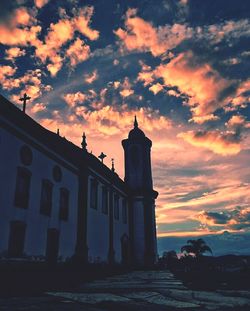 Low angle view of silhouette building against sky during sunset