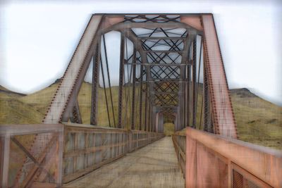 Bridge in building against sky