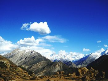 Scenic view of mountains against blue sky