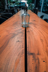 Close-up of empty glass bottle on table
