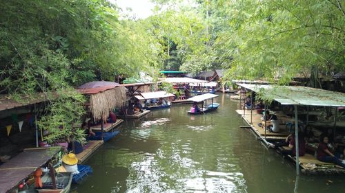 Boats in river along buildings