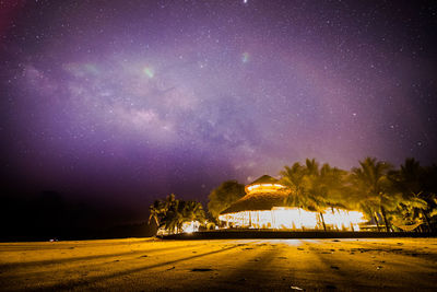 Scenic view of illuminated building against sky at night