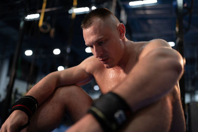 Sweaty sportsman resting during training