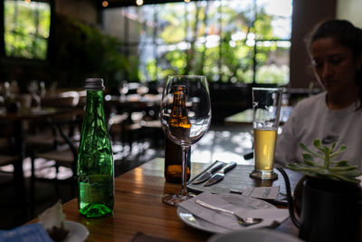 Portrait of woman drinking glass on table