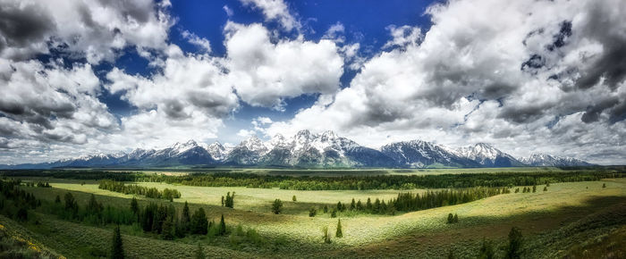 Scenic view of field and mountains against sky