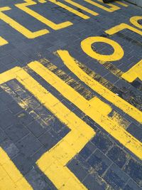 High angle view of arrow sign on road