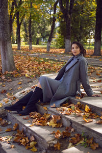 Young woman sitting in park