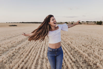 Young woman standing on field