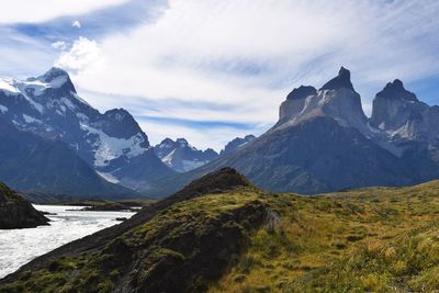 Scenic view of mountains against cloudy sky