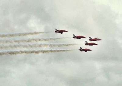 Low angle view of people against sky