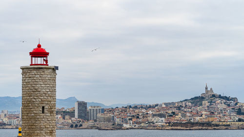 The lighthouse at the chateau d'if overlooking the bay of marseille in a cloudy day, france