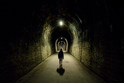 Full length of child in illuminated tunnel