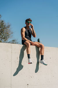 Full length of man wearing sunglasses against clear sky