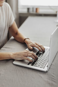 Woman's hand on laptop keyboard