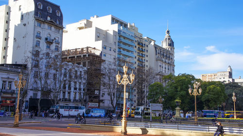 City street by buildings against sky