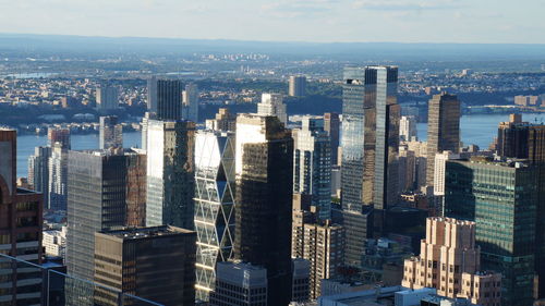 Aerial view of buildings in city against sky