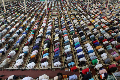 High angle view of people sitting in row