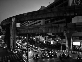 Vehicles on road in city against sky