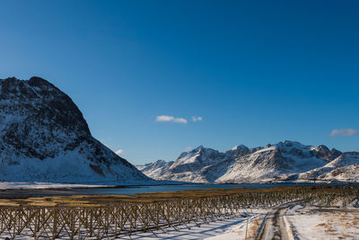 Scenic view of snowcapped mountains against blue sky