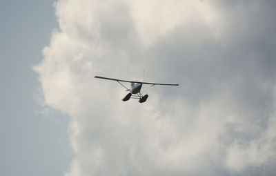Low angle view of airplane flying in sky