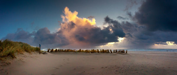 Panoramic view of beach against sky during sunset