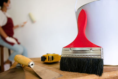 Close-up of hand holding coffee cup on table at home