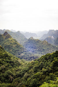 Scenic view of valley and mountains against sky