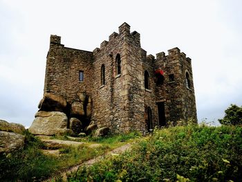 Low angle view of old ruin against sky