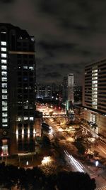 Illuminated cityscape against sky at night