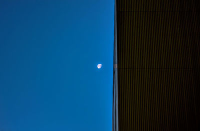 Low angle view of building against clear blue sky at dusk