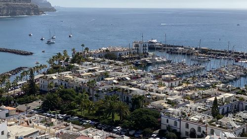 High angle view of buildings by sea against sky