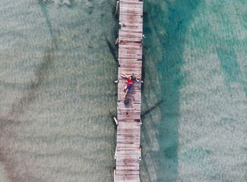 High angle view of people on pier against wall