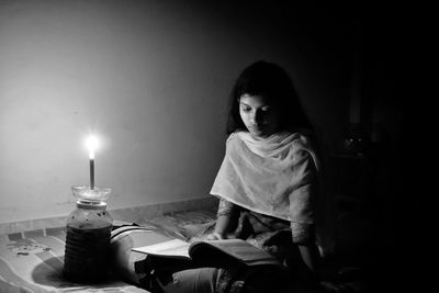 Girl sitting on table at home