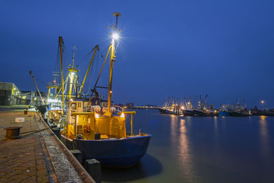 Fishing boats in the harbor from lauwersoog in the netherlands at night