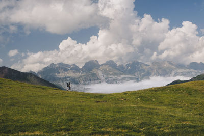 Young man hikes around mt aspe in the pyrenees, while carrying his son