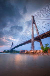 Low angle view of suspension bridge over river