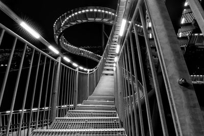 Low angle view of illuminated rollercoaster at night