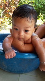Portrait of cute baby girl sitting outdoors