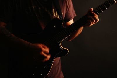 Close-up of man playing guitar