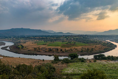 Scenic view of landscape and mountains against sky