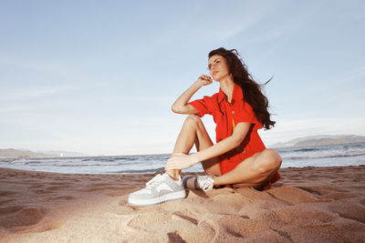 Young woman sitting at beach