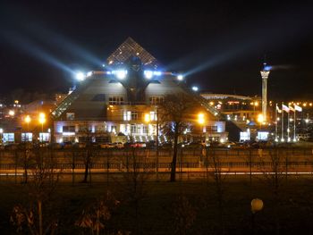 Illuminated building against sky at night