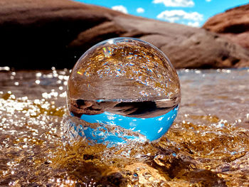 Close-up of hand holding glass of water