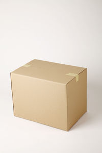 High angle view of brown cardboard box against white background