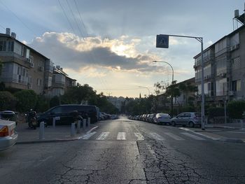 Street amidst buildings in city against sky